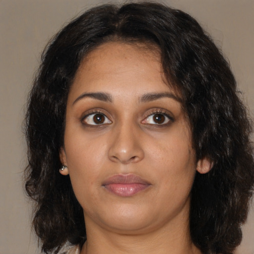 Neutral black young-adult female with medium  brown hair and brown eyes