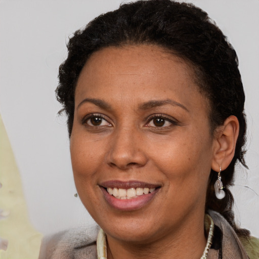 Joyful black adult female with short  brown hair and brown eyes