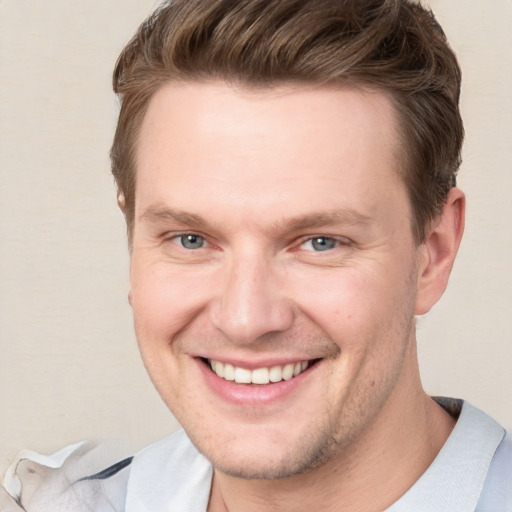 Joyful white adult male with short  brown hair and grey eyes