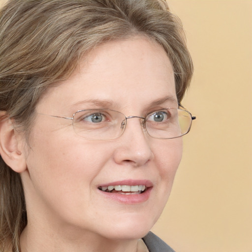 Joyful white adult female with long  brown hair and blue eyes