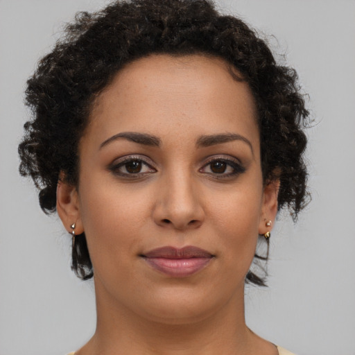 Joyful latino young-adult female with short  brown hair and brown eyes