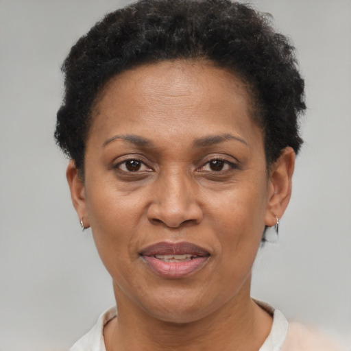 Joyful black adult female with short  brown hair and brown eyes