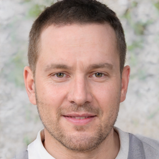 Joyful white adult male with short  brown hair and brown eyes