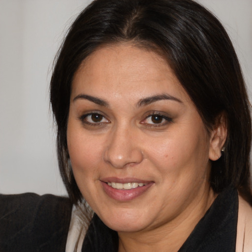 Joyful white adult female with medium  brown hair and brown eyes
