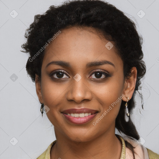 Joyful black young-adult female with long  black hair and brown eyes