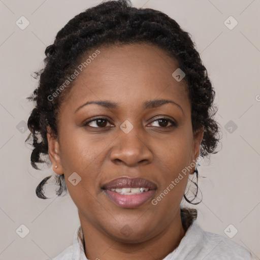 Joyful black adult female with medium  brown hair and brown eyes