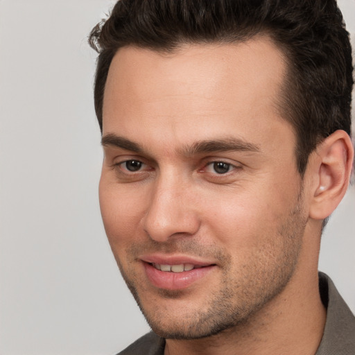 Joyful white young-adult male with short  brown hair and brown eyes