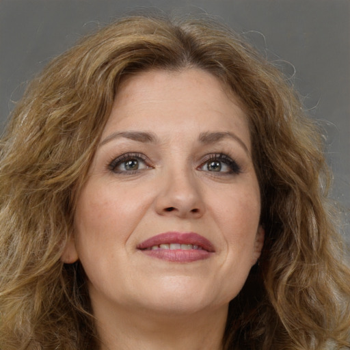 Joyful white young-adult female with long  brown hair and green eyes