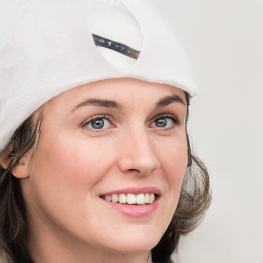 Joyful white young-adult female with medium  brown hair and blue eyes