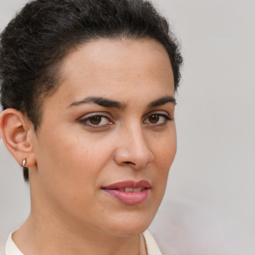 Joyful latino young-adult female with short  brown hair and brown eyes