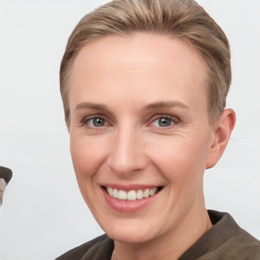 Joyful white young-adult female with short  brown hair and grey eyes