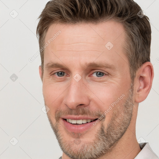 Joyful white adult male with short  brown hair and brown eyes