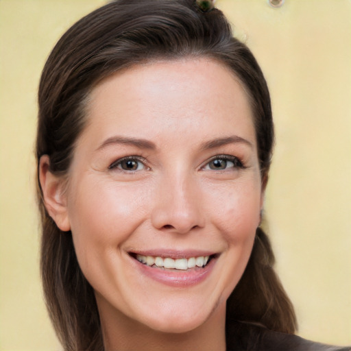 Joyful white young-adult female with long  brown hair and brown eyes