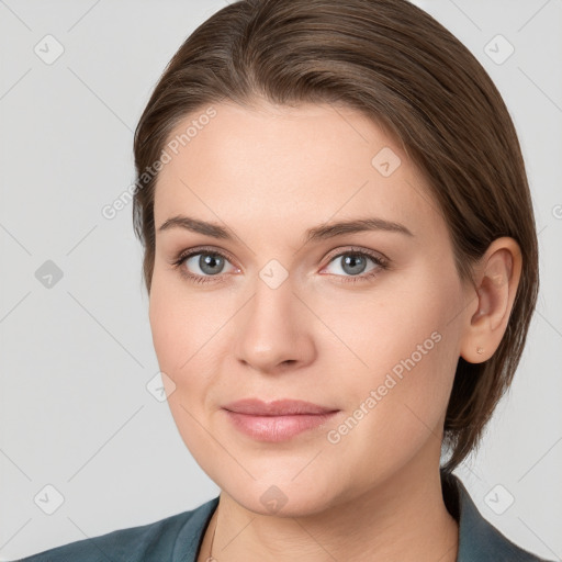 Joyful white young-adult female with medium  brown hair and grey eyes