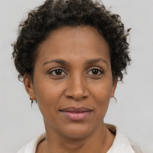 Joyful black adult female with short  brown hair and brown eyes