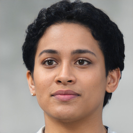 Joyful latino young-adult female with short  black hair and brown eyes
