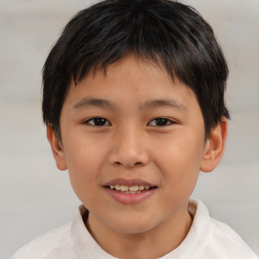 Joyful asian child male with short  brown hair and brown eyes