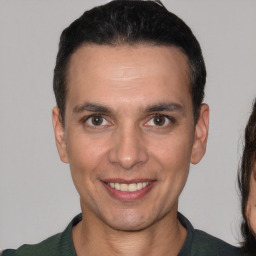 Joyful white young-adult male with short  black hair and brown eyes