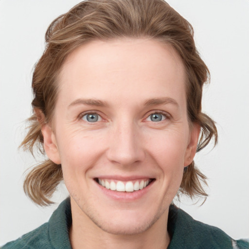 Joyful white young-adult female with medium  brown hair and blue eyes