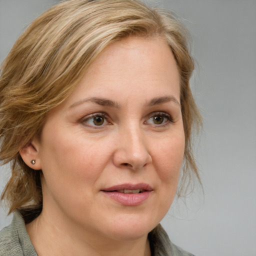 Joyful white adult female with medium  brown hair and brown eyes