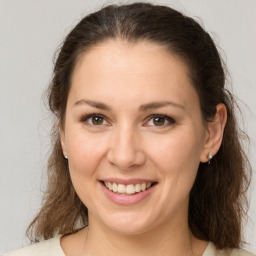 Joyful white young-adult female with medium  brown hair and brown eyes