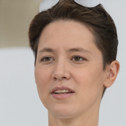 Joyful white adult female with short  brown hair and brown eyes