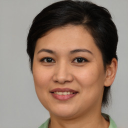 Joyful asian young-adult female with medium  brown hair and brown eyes