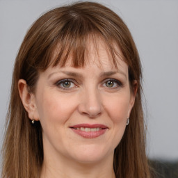 Joyful white adult female with long  brown hair and grey eyes