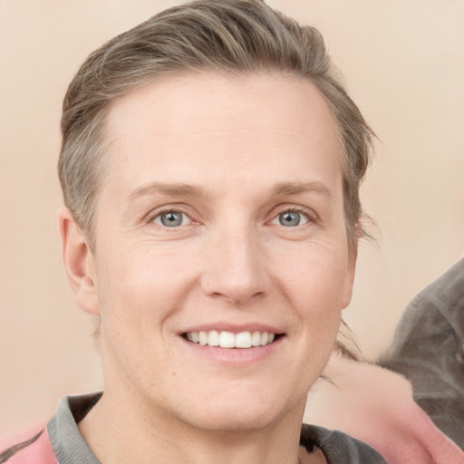 Joyful white adult female with short  brown hair and grey eyes