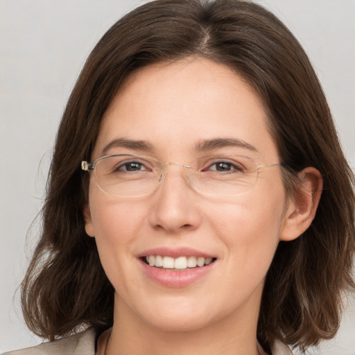 Joyful white young-adult female with medium  brown hair and brown eyes