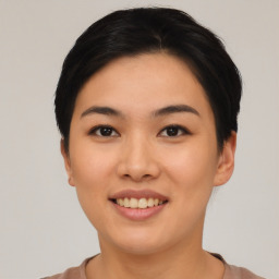 Joyful asian young-adult female with short  black hair and brown eyes