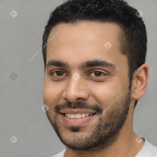 Joyful white young-adult male with short  black hair and brown eyes