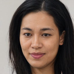 Joyful asian young-adult female with long  brown hair and brown eyes