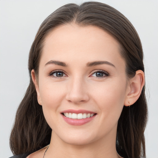 Joyful white young-adult female with long  brown hair and grey eyes