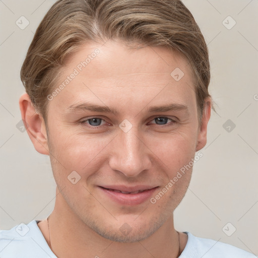 Joyful white young-adult male with short  brown hair and grey eyes