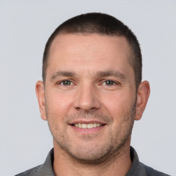 Joyful white adult male with short  brown hair and brown eyes