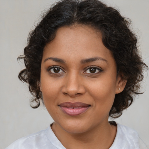 Joyful black young-adult female with medium  brown hair and brown eyes