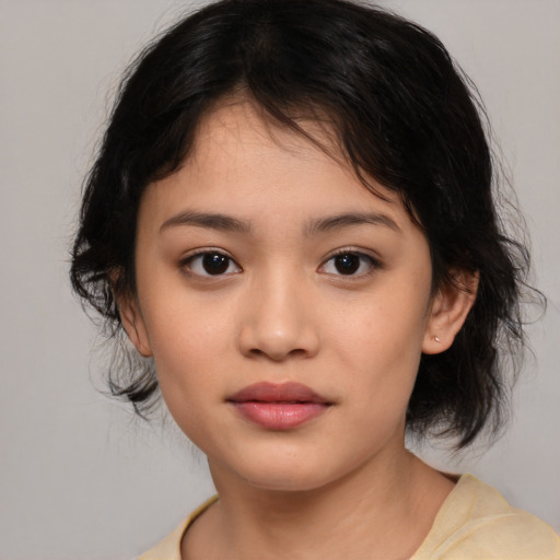 Joyful asian child female with medium  brown hair and brown eyes