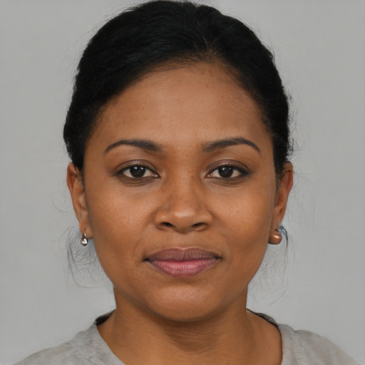 Joyful black young-adult female with short  black hair and brown eyes