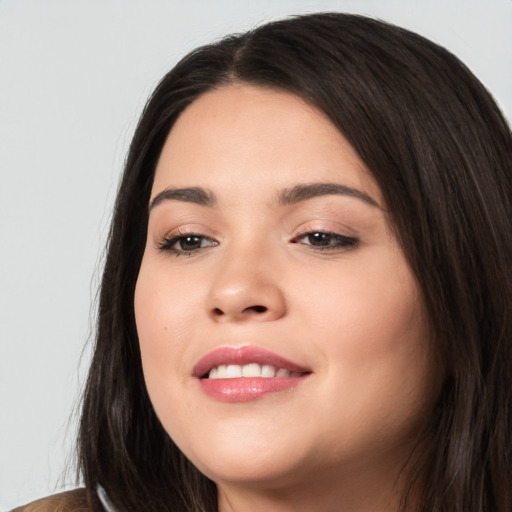 Joyful white young-adult female with long  black hair and brown eyes