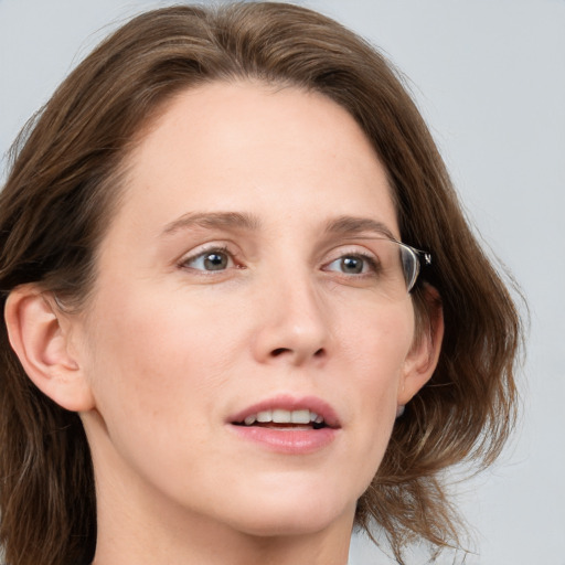 Joyful white young-adult female with medium  brown hair and green eyes