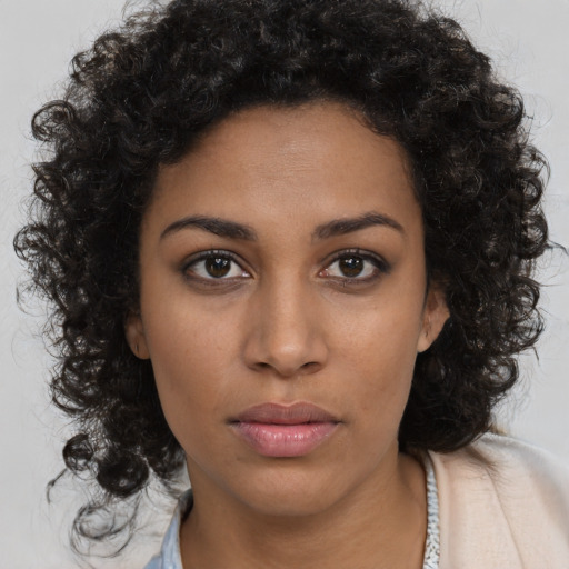 Neutral black young-adult female with long  brown hair and brown eyes