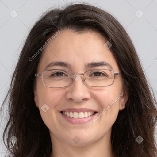 Joyful white adult female with long  brown hair and grey eyes