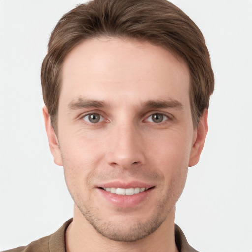 Joyful white young-adult male with short  brown hair and grey eyes