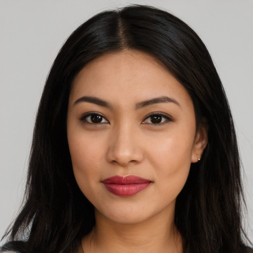 Joyful latino young-adult female with long  brown hair and brown eyes