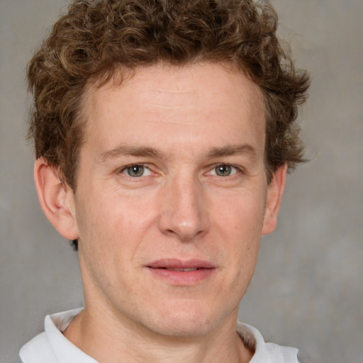 Joyful white adult male with short  brown hair and grey eyes