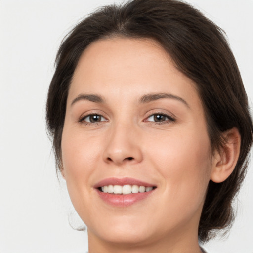 Joyful white young-adult female with medium  brown hair and brown eyes