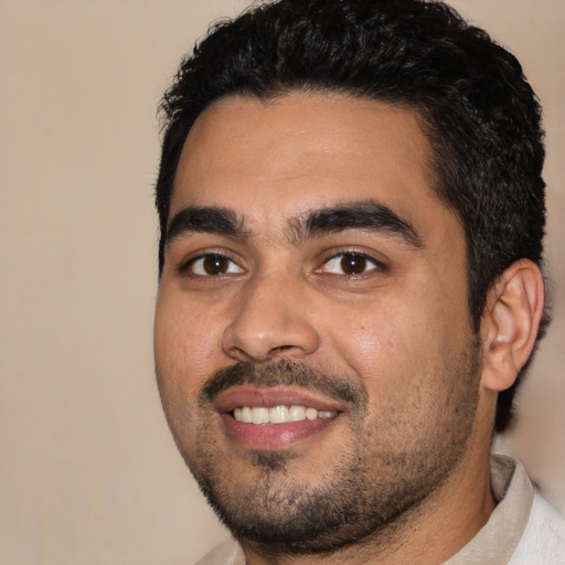 Joyful latino young-adult male with short  black hair and brown eyes