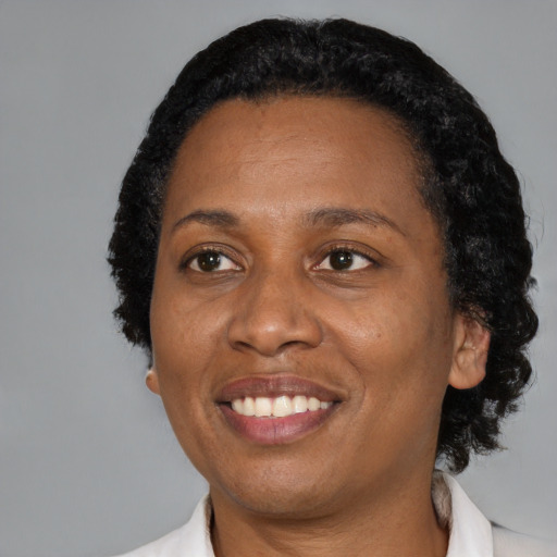 Joyful black adult female with short  black hair and brown eyes