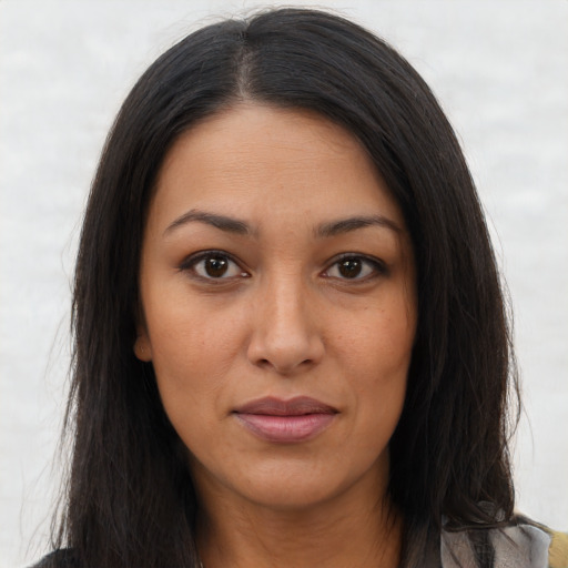 Joyful latino young-adult female with long  brown hair and brown eyes